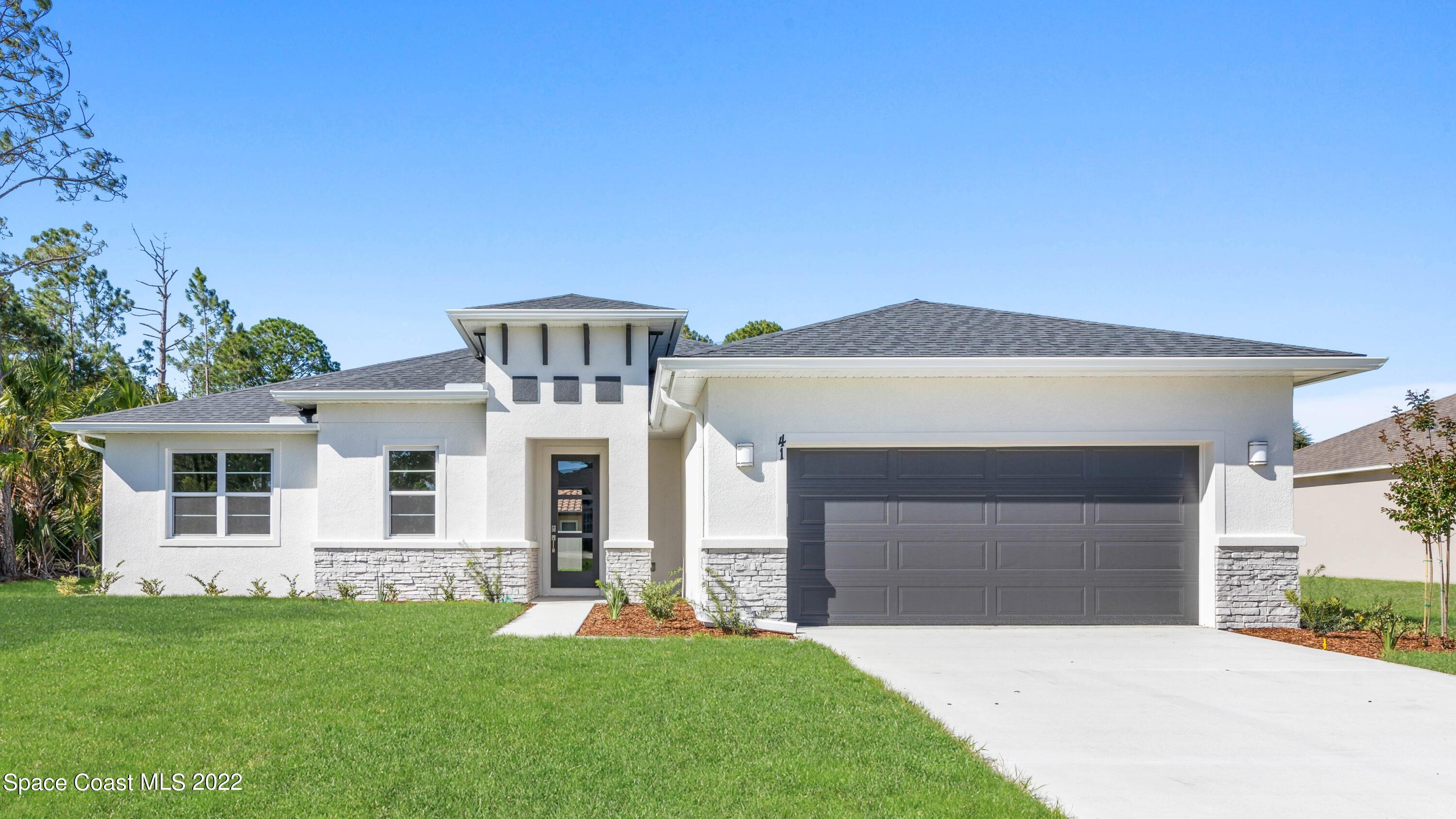 1275 Packer Road Southeast Palm Bay, FL 32909 - Photo 1 of 20 front view of a house with a yard