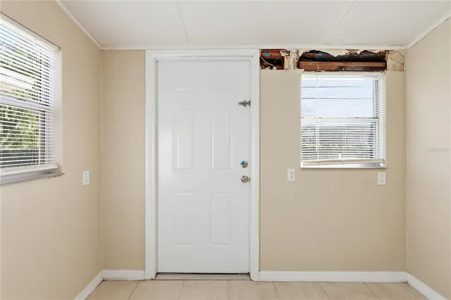 a view of a kitchen with dishwasher and white cabinets