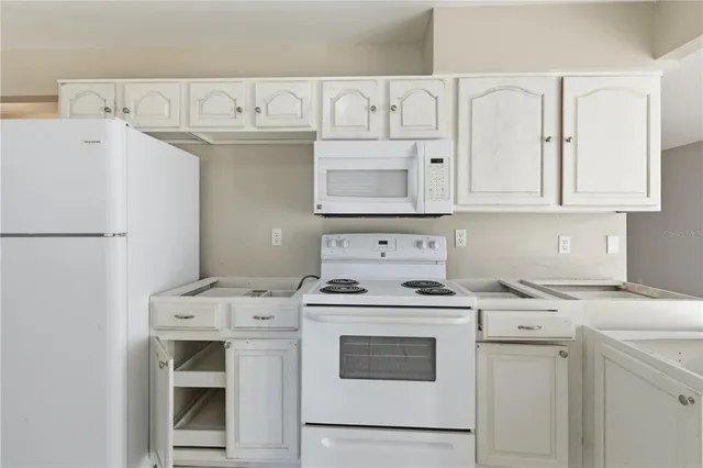 a kitchen with stainless steel appliances a sink stove and cabinets