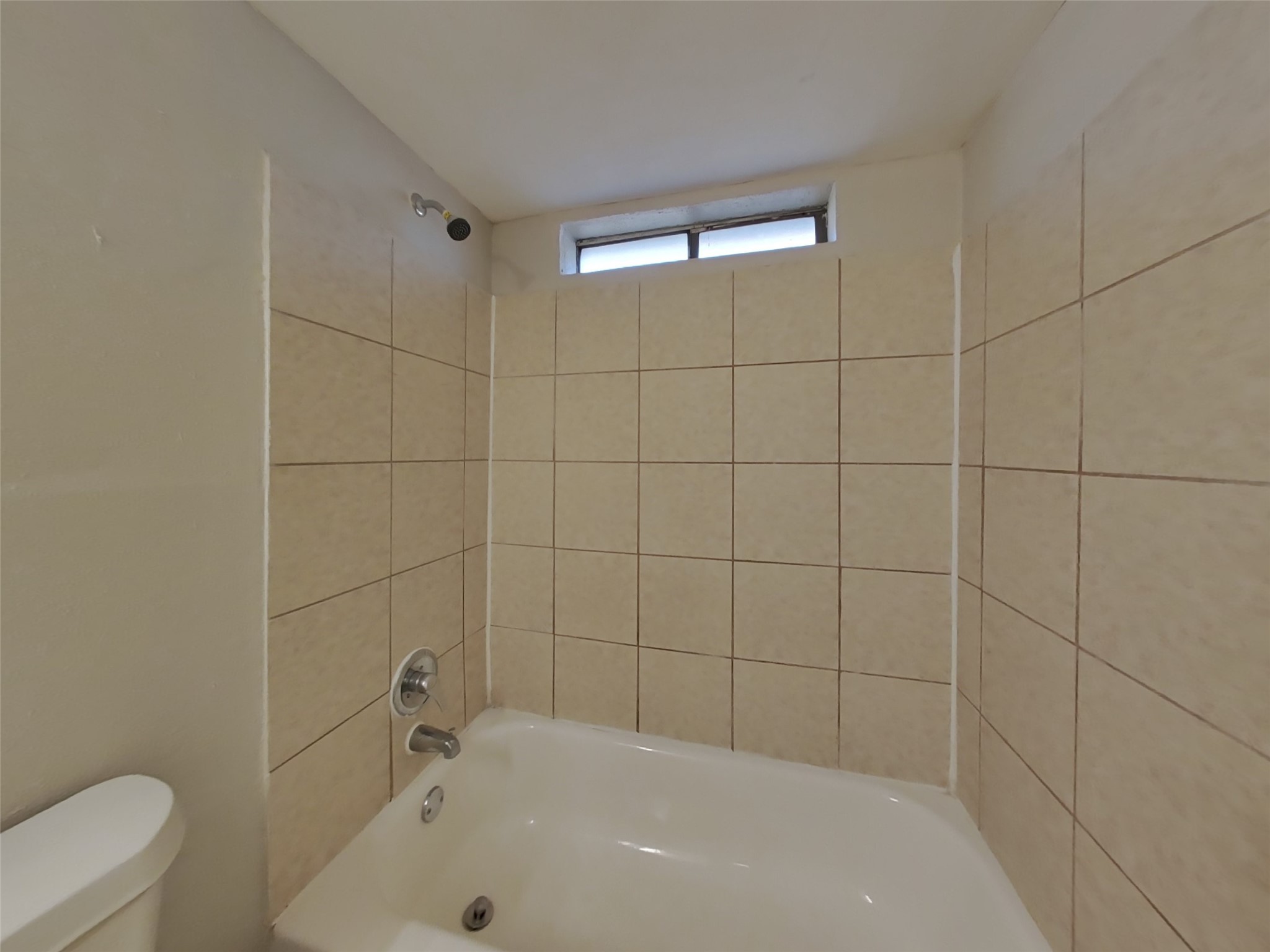 3815 Shadow Trail Houston, TX 77084 - Photo 14 of 16 a bathroom with a bathtub and toilet