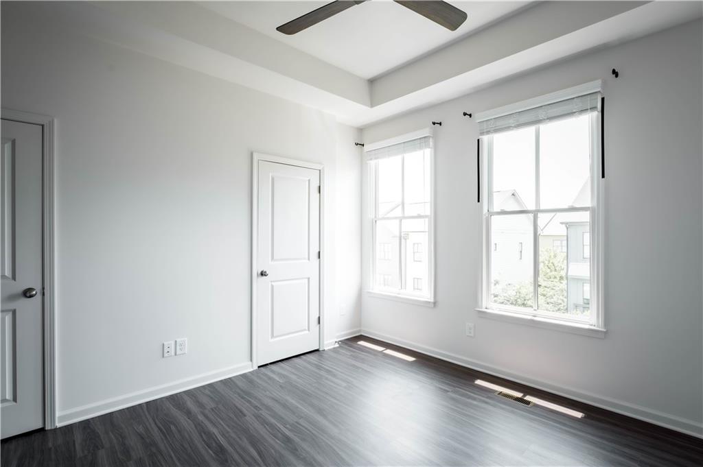 709 Needletail Way Atlanta, GA 30312 - Photo 16 of 29 an empty room with wooden floor and windows