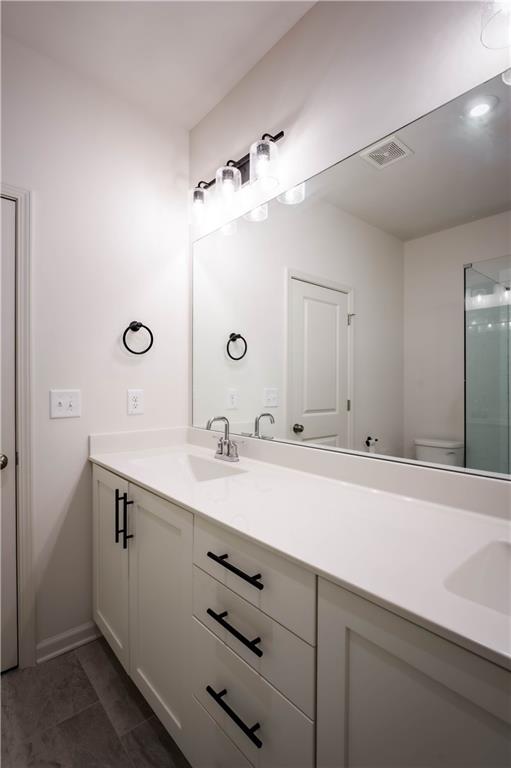 709 Needletail Way Atlanta, GA 30312 - Photo 17 of 29 a bathroom with a sink and a mirror