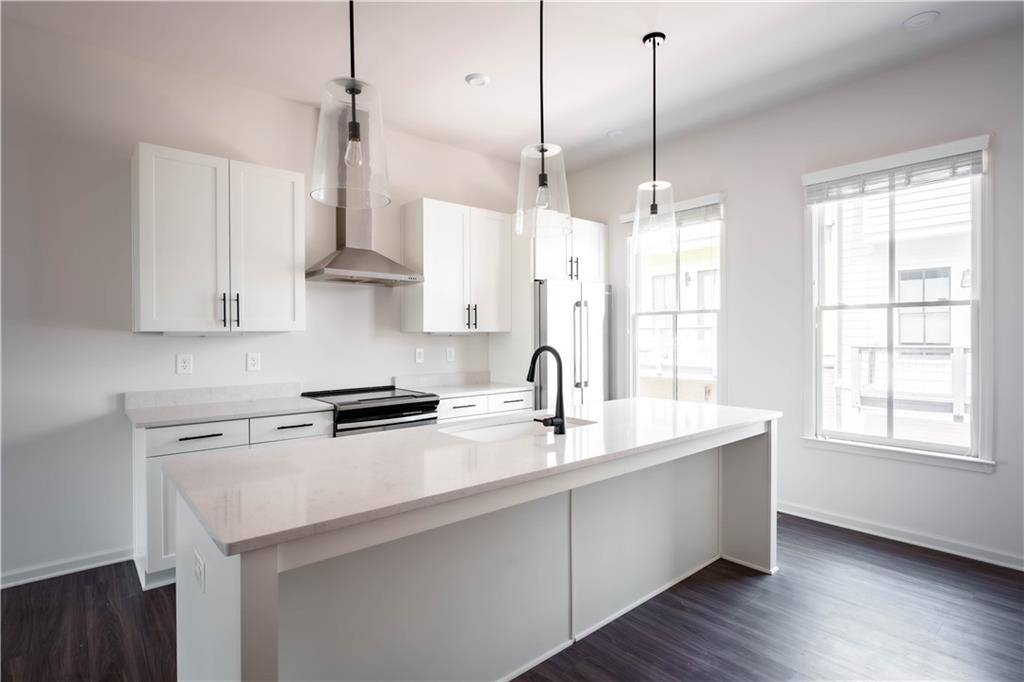 709 Needletail Way Atlanta, GA 30312 - Photo 2 of 29 a kitchen with stainless steel appliances granite countertop a sink a window and white cabinets