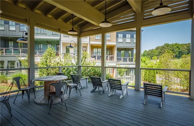 a view of a house with swimming pool and sitting area