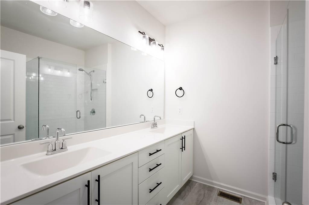 709 Needletail Way Atlanta, GA 30312 - Photo 3 of 29 a bathroom with a sink double vanity and a mirror