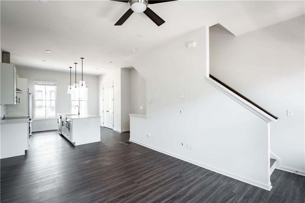 709 Needletail Way Atlanta, GA 30312 - Photo 4 of 29 a view of an empty room with wooden floor and windows