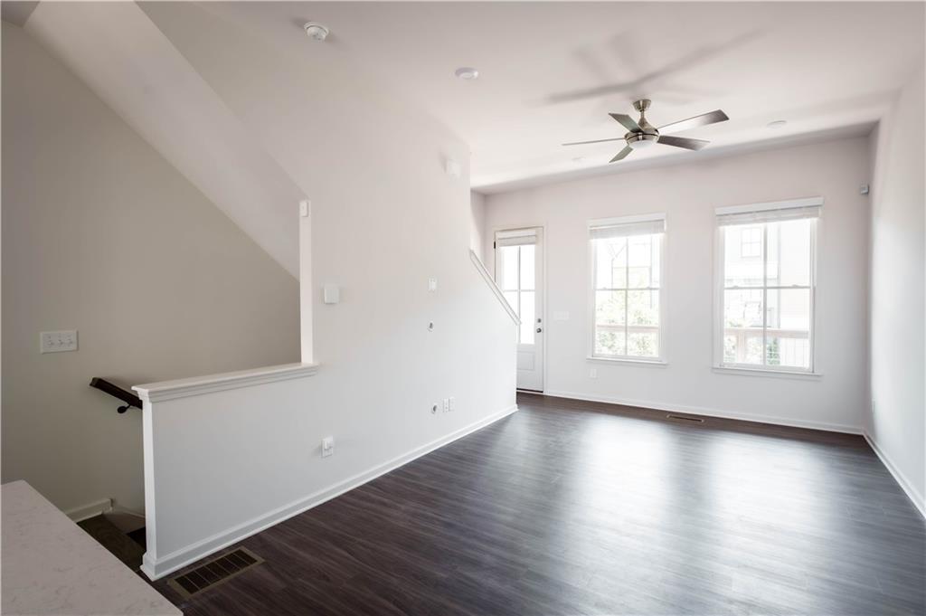 709 Needletail Way Atlanta, GA 30312 - Photo 6 of 29 an empty room with wooden floor fan and windows