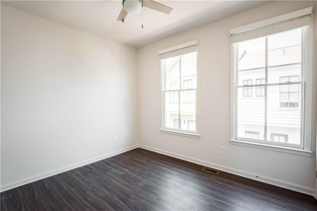 709 Needletail Way Atlanta, GA 30312 - Photo 7 of 29 an empty room with wooden floor and windows