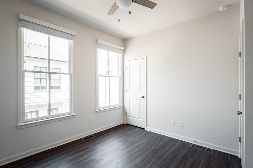 709 Needletail Way Atlanta, GA 30312 - Photo 8 of 29 an empty room with wooden floor and windows