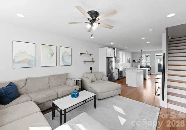 a living room with furniture and kitchen view