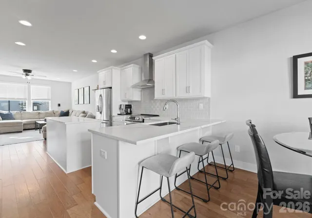 a view of kitchen with cabinets table and chairs