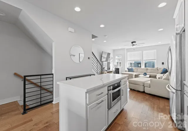 a kitchen with white cabinets and white appliances