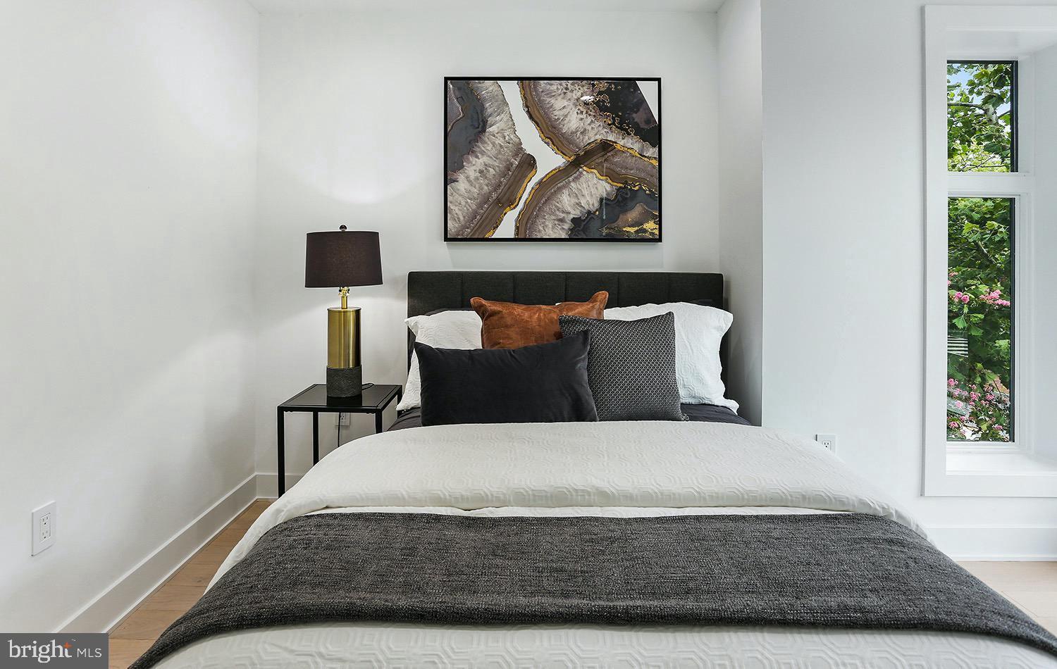 4 R Street Northwest, Unit 3 Washington, DC 20001 - Photo 16 of 28 a large bed sitting in a bedroom next to a window