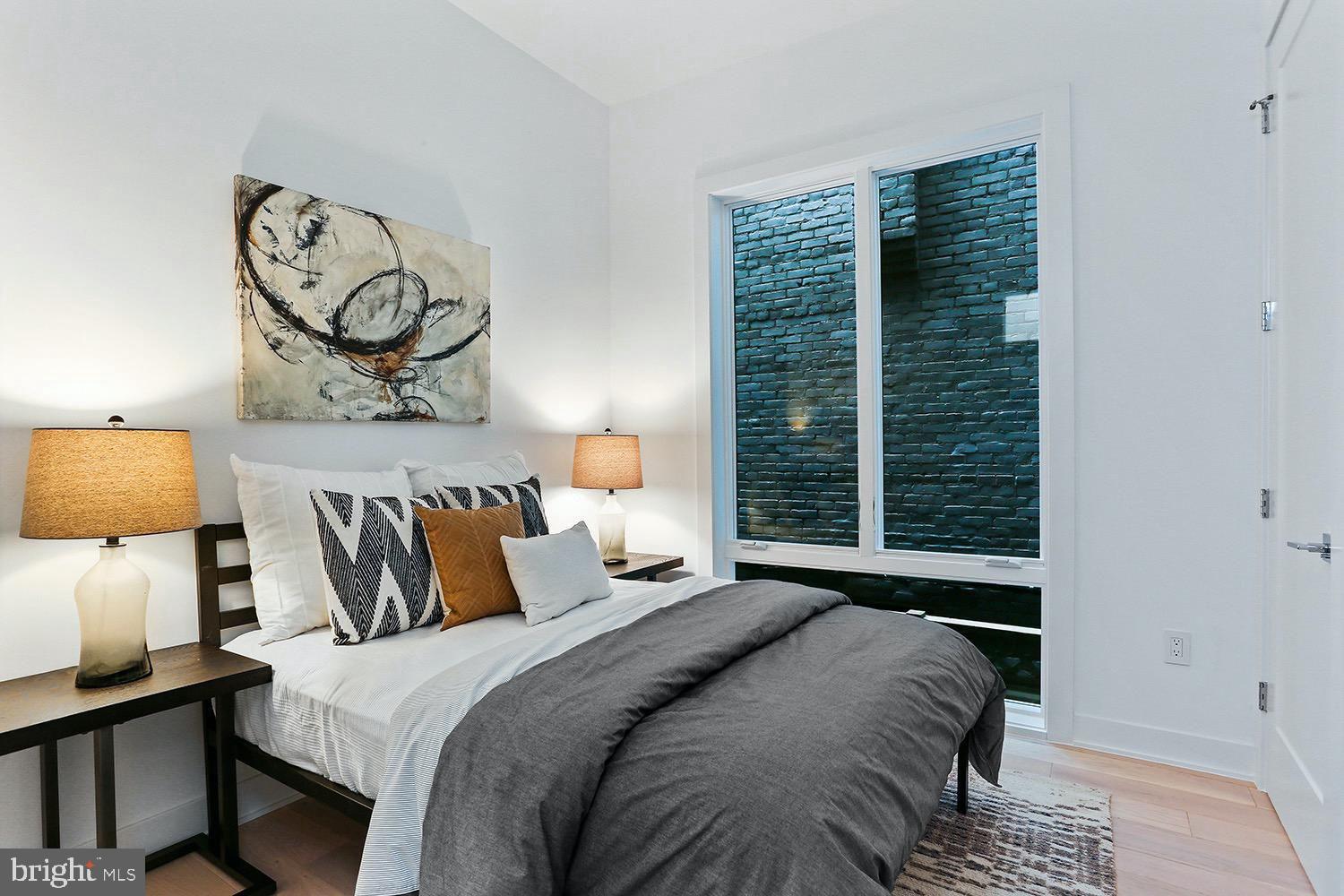 4 R Street Northwest, Unit 3 Washington, DC 20001 - Photo 25 of 28 a bedroom with a bed and painting on the wall