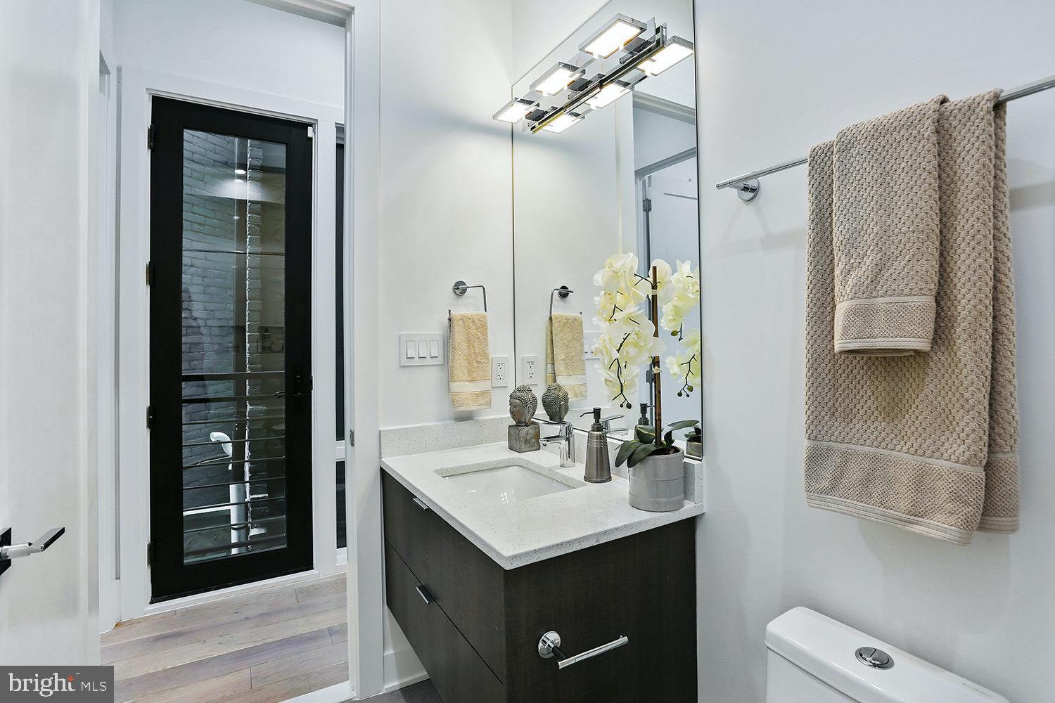4 R Street Northwest, Unit 3 Washington, DC 20001 - Photo 26 of 28 a bathroom with a sink and a mirror