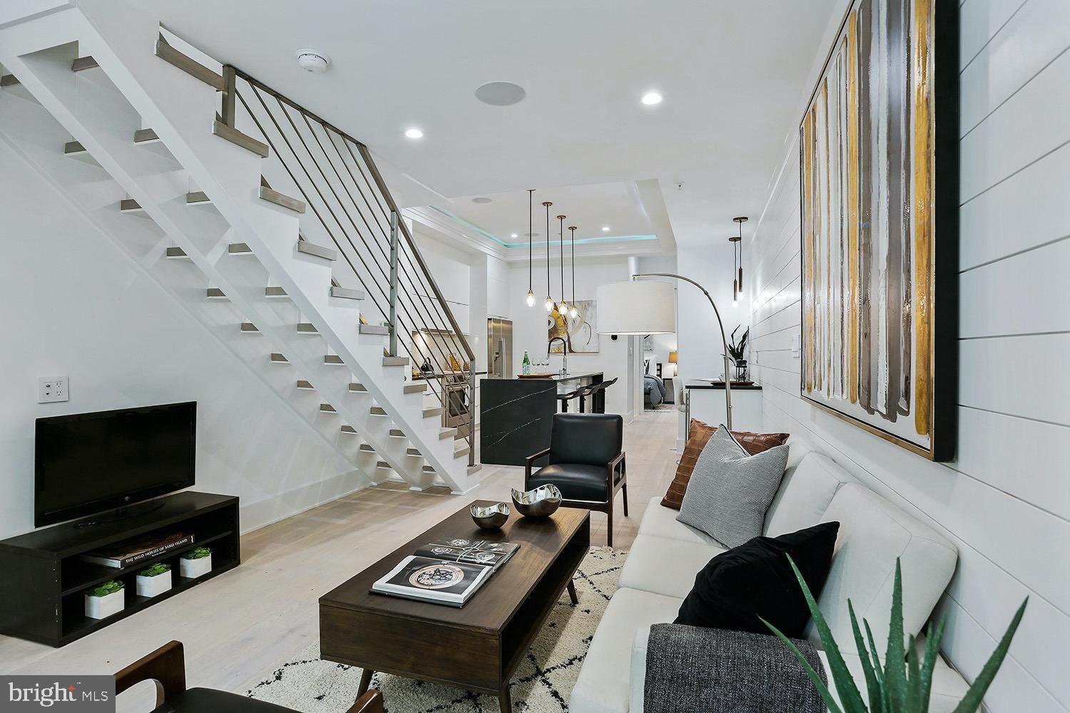 4 R Street Northwest, Unit 3 Washington, DC 20001 - Photo 4 of 28 a living room with furniture and a flat screen tv