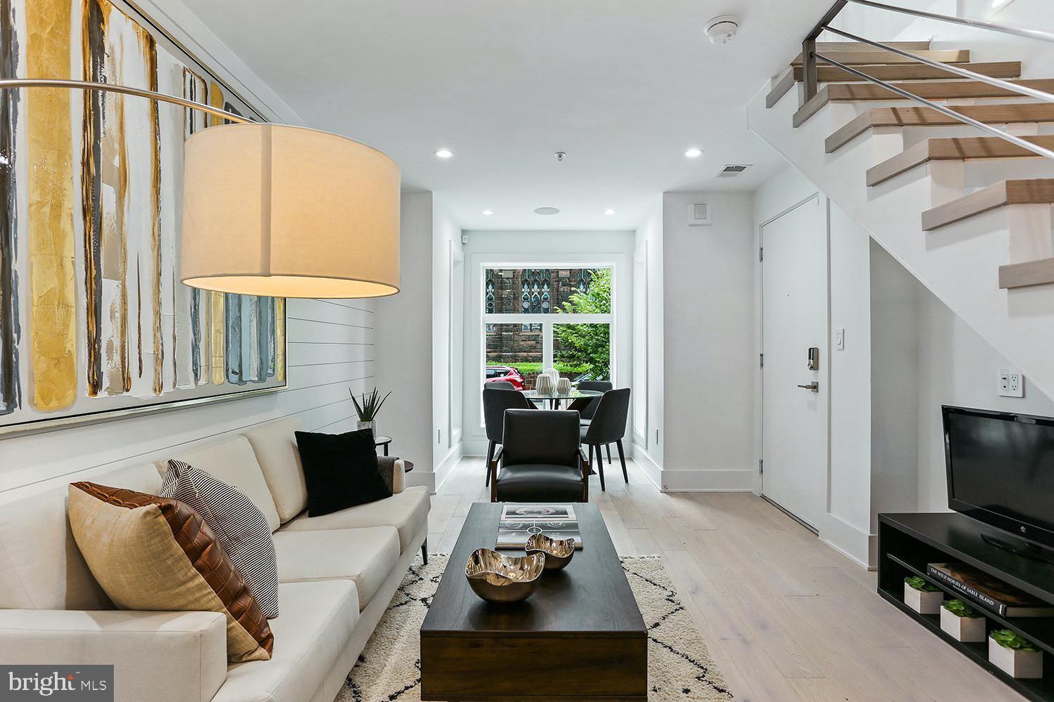 4 R Street Northwest, Unit 3 Washington, DC 20001 - Photo 5 of 28 a living room with furniture and a flat screen tv