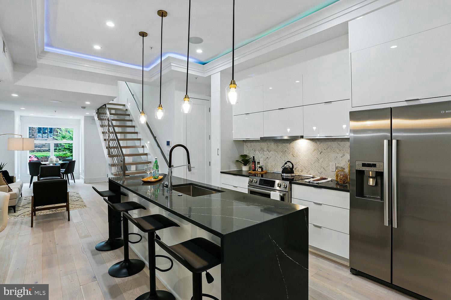 4 R Street Northwest, Unit 3 Washington, DC 20001 - Photo 6 of 28 a kitchen with granite countertop a table chairs stainless steel appliances and cabinets