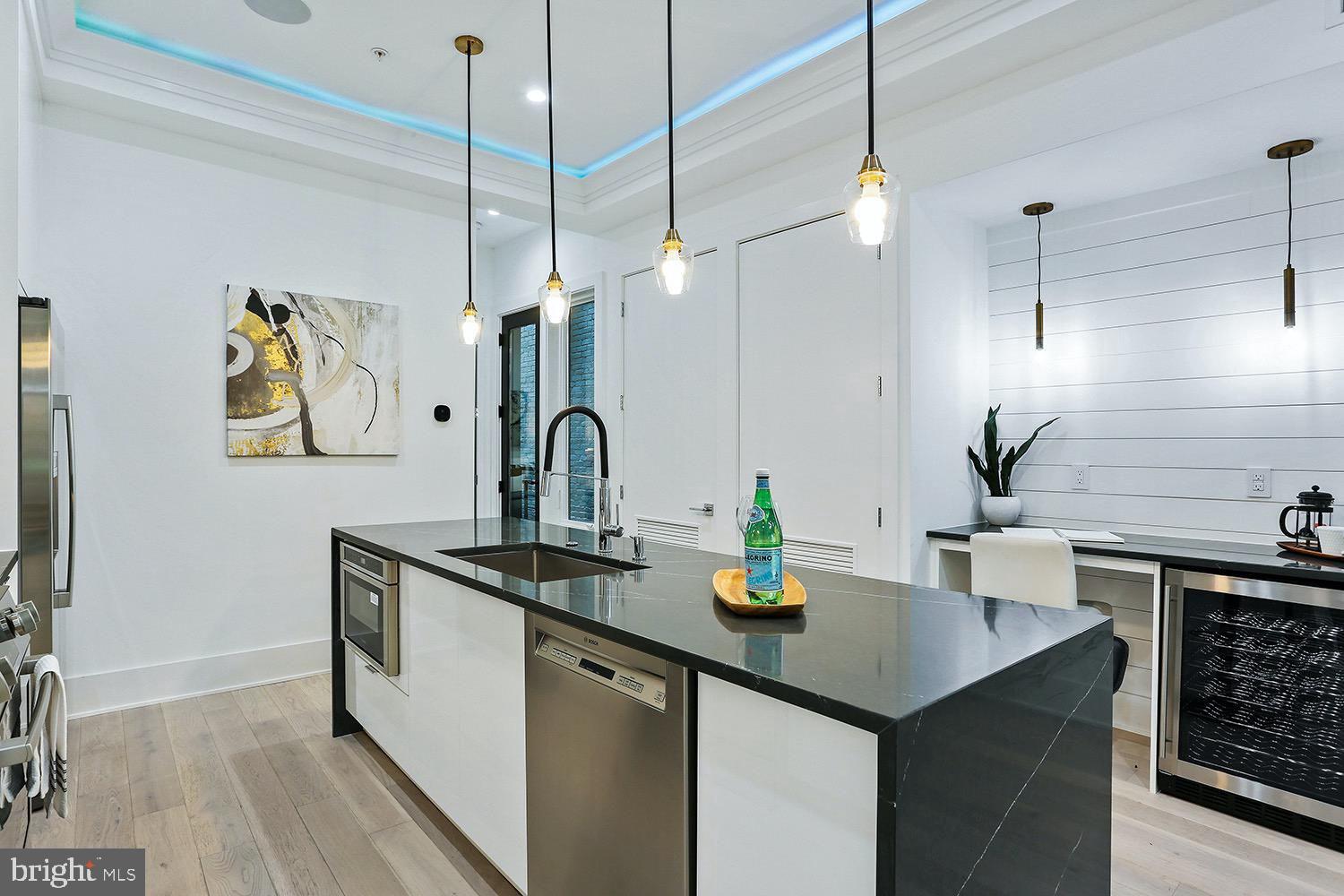 4 R Street Northwest, Unit 3 Washington, DC 20001 - Photo 8 of 28 a kitchen with sink a counter and cabinets