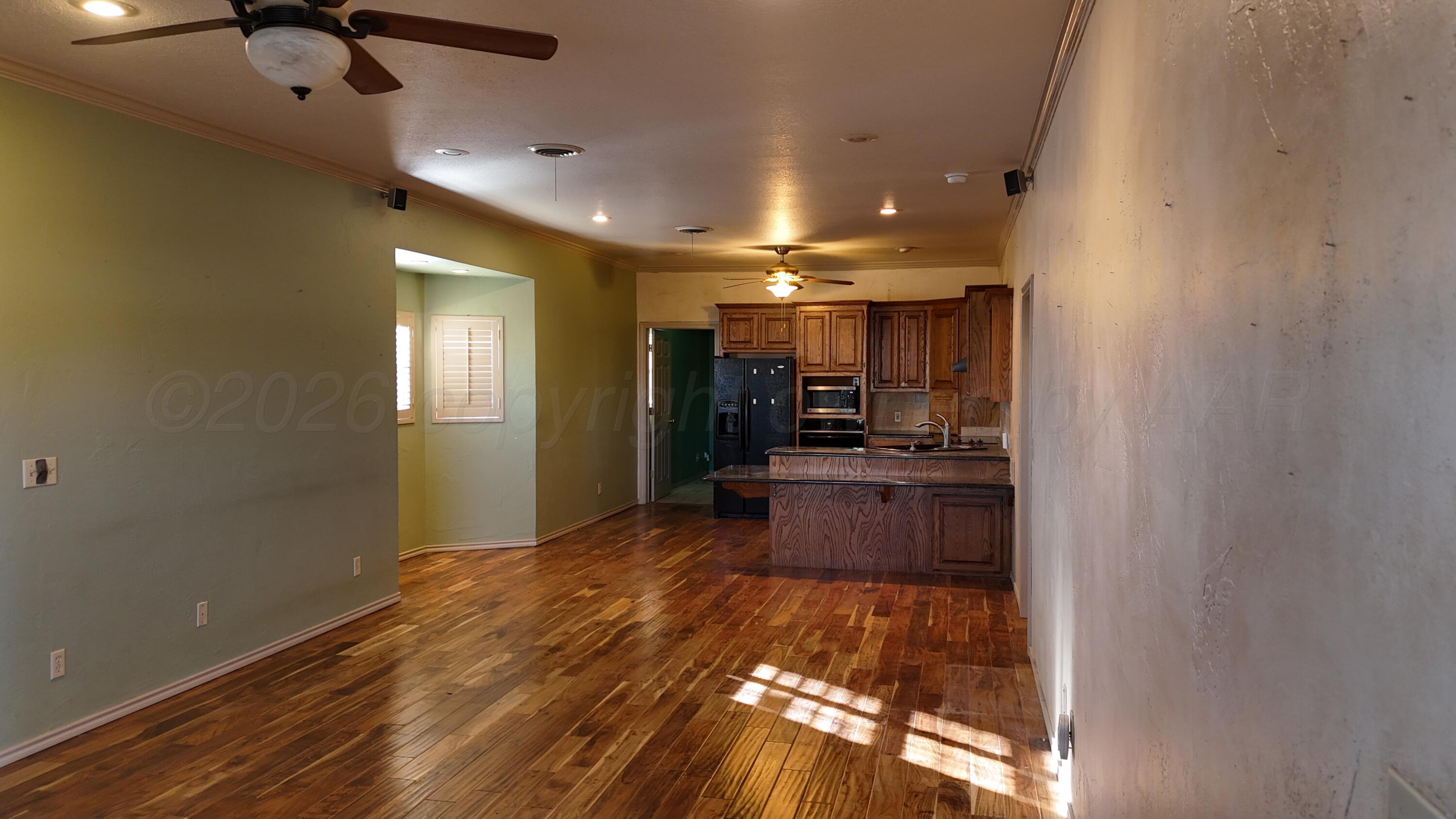 2100 13th Avenue Canyon, TX 79015 - Photo 7 of 11 a open kitchen with a sink stainless steel appliances and cabinets