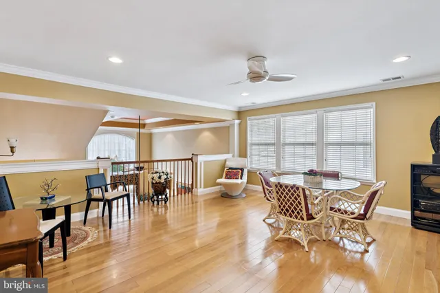 a dining room with furniture window and wooden floor