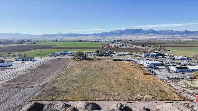 650 North State Street Preston, ID 83263 - Photo 5 of 14 Aerial view of sparsely populated area with a mountain backdrop and large plots for crops