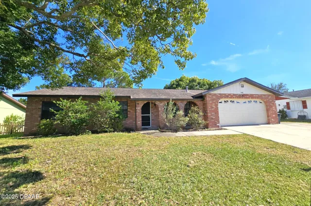 a front view of house with yard and green space