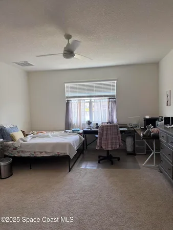 a bedroom with furniture and window