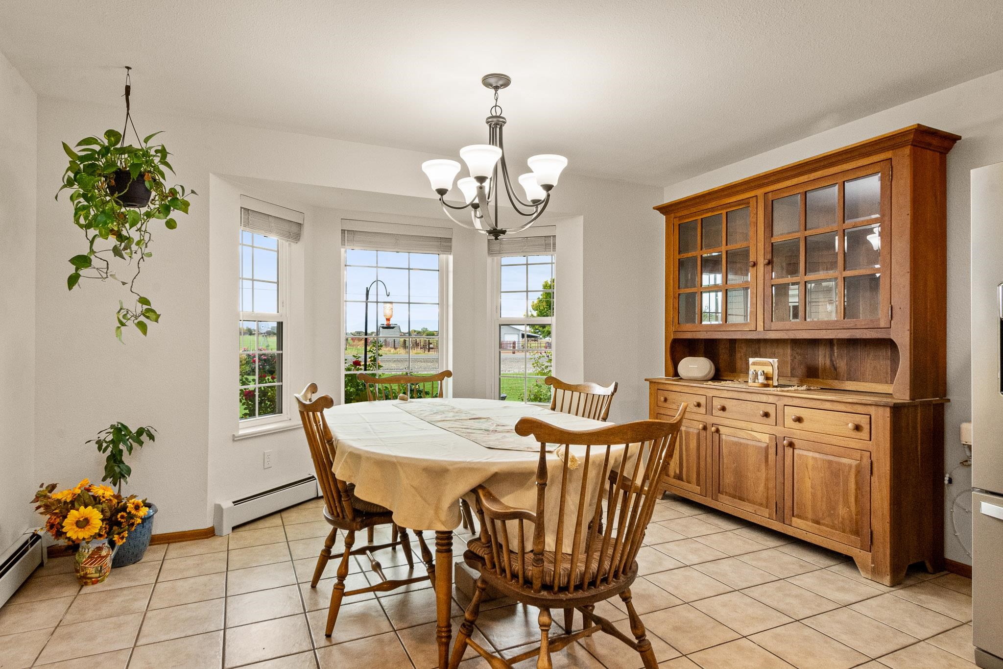 1185-17 17 1/2 Road Fruita, CO 81521 - Photo 11 of 35 a dining room filled chandelier and wooden floor