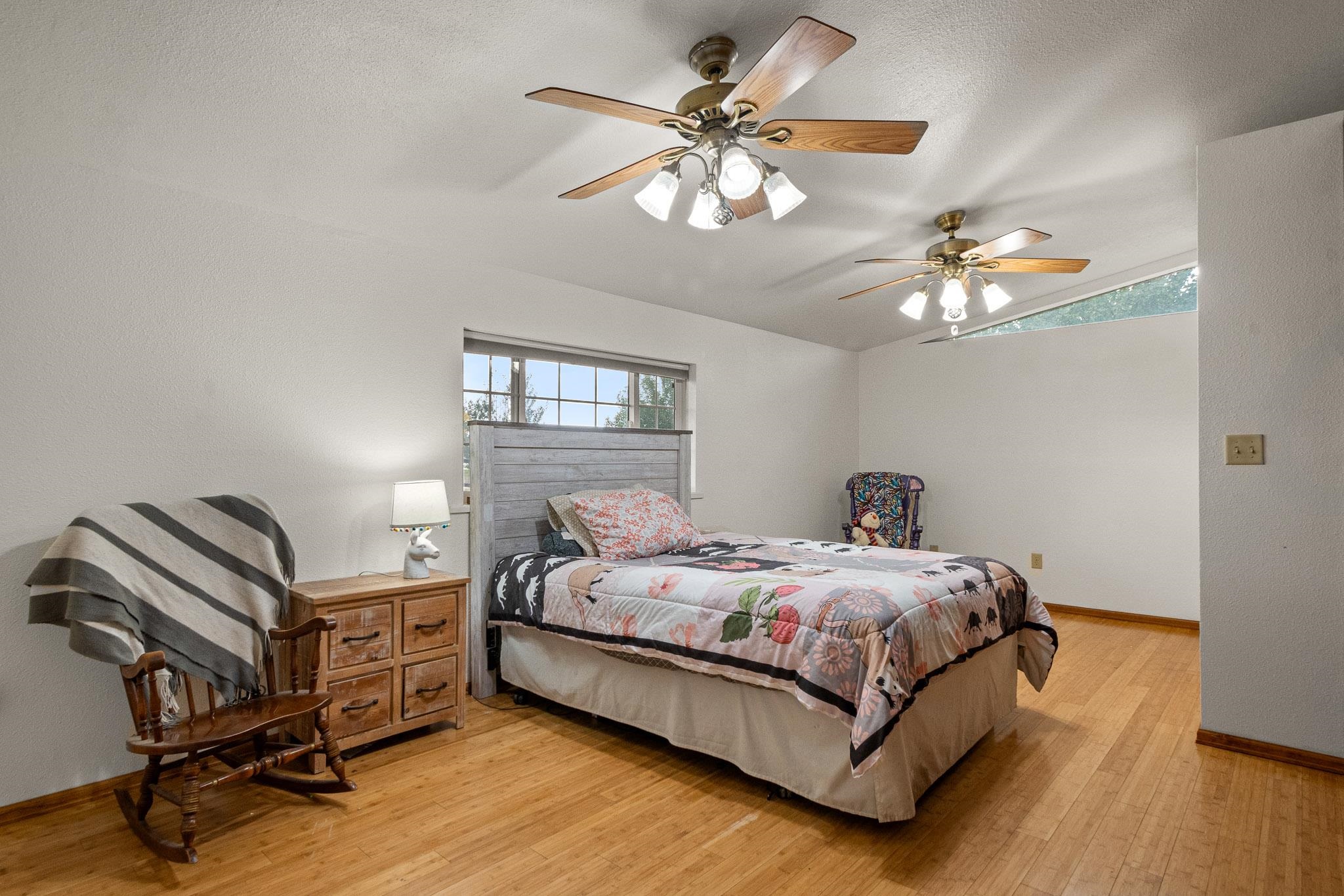 1185-17 17 1/2 Road Fruita, CO 81521 - Photo 15 of 35 a bedroom with a bed and a chandelier