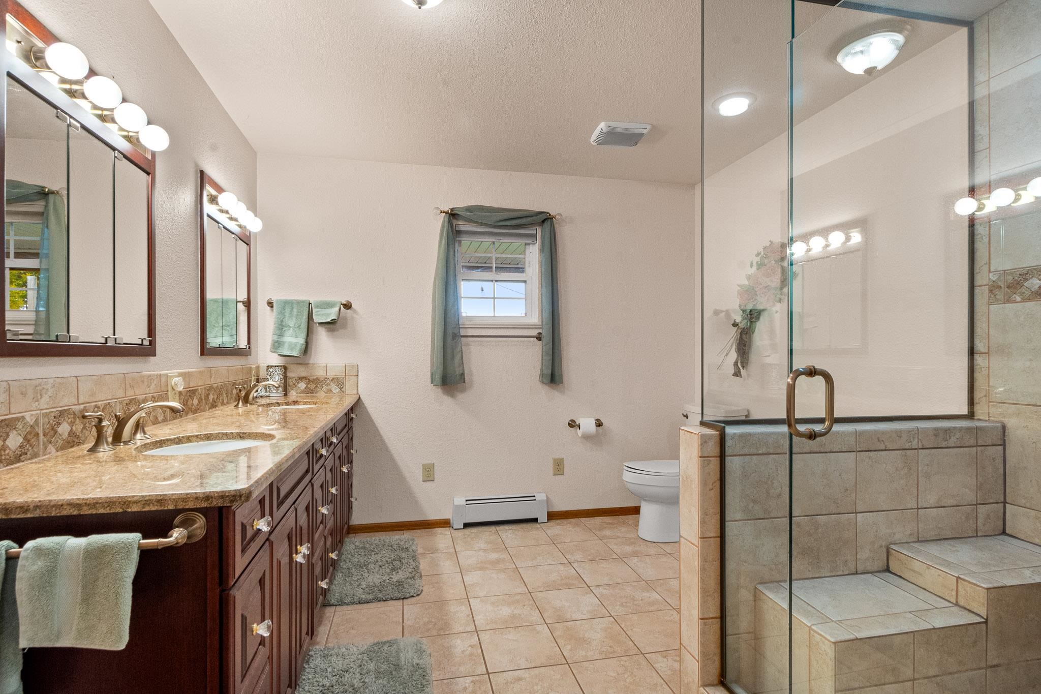 1185-17 17 1/2 Road Fruita, CO 81521 - Photo 21 of 35 a spacious bathroom with a sink a mirror and a shower