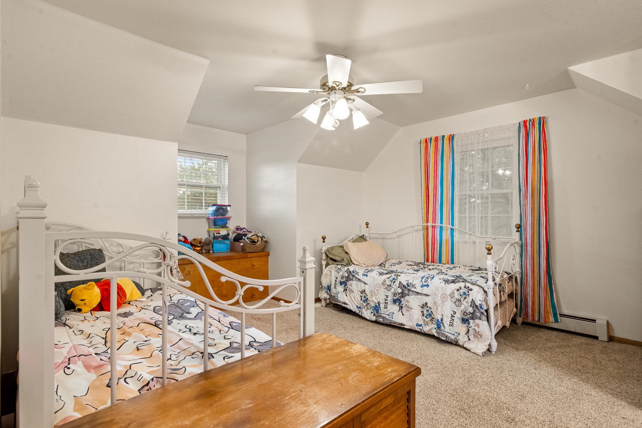 1185-17 17 1/2 Road Fruita, CO 81521 - Photo 24 of 35 a bedroom with bed and a chandelier