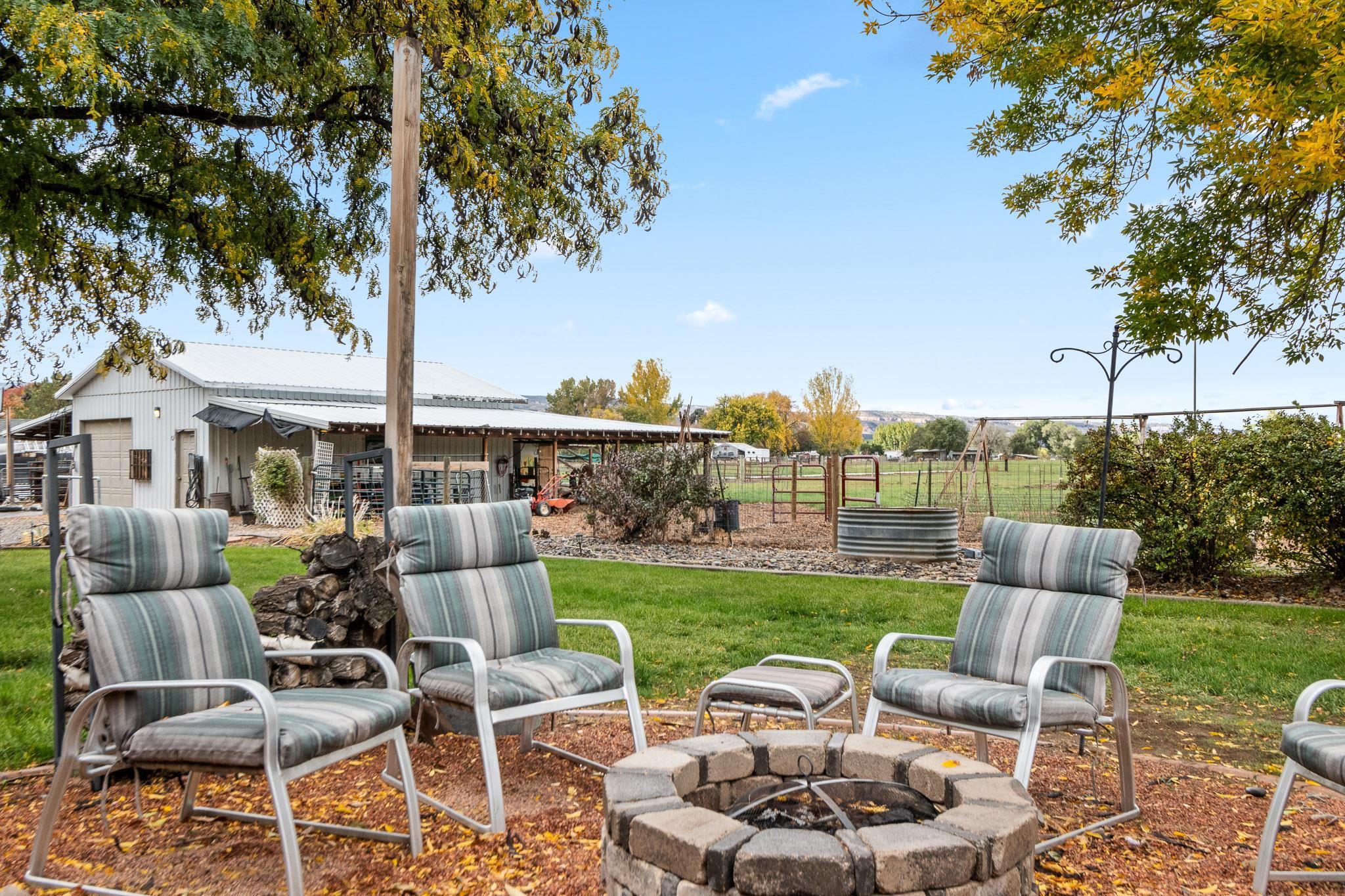 1185-17 17 1/2 Road Fruita, CO 81521 - Photo 29 of 35 a view of a patio with couches chairs and a table and chairs with the view of lake view