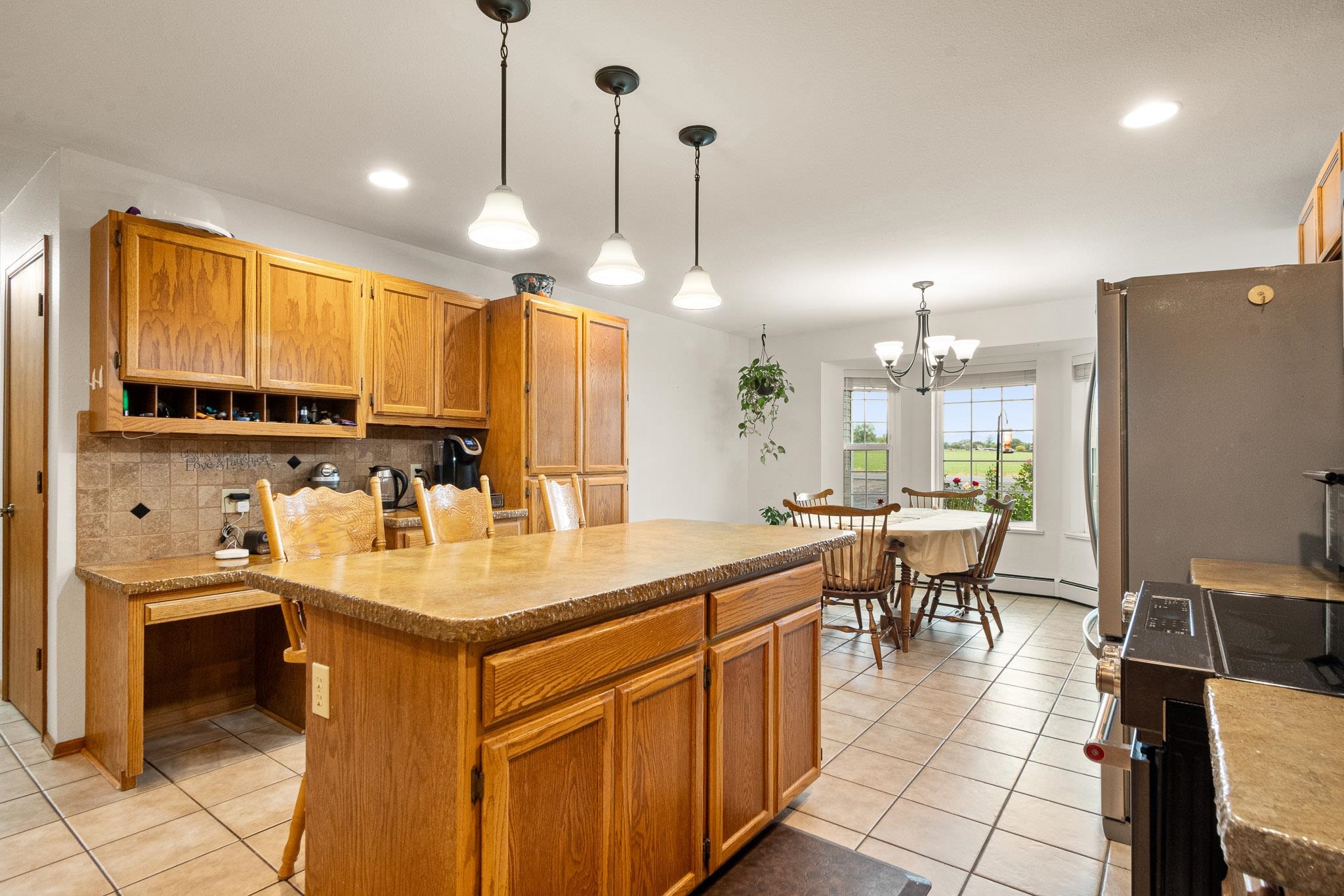 1185-17 17 1/2 Road Fruita, CO 81521 - Photo 8 of 35 a kitchen with kitchen island granite countertop a sink a counter top space appliances and cabinets
