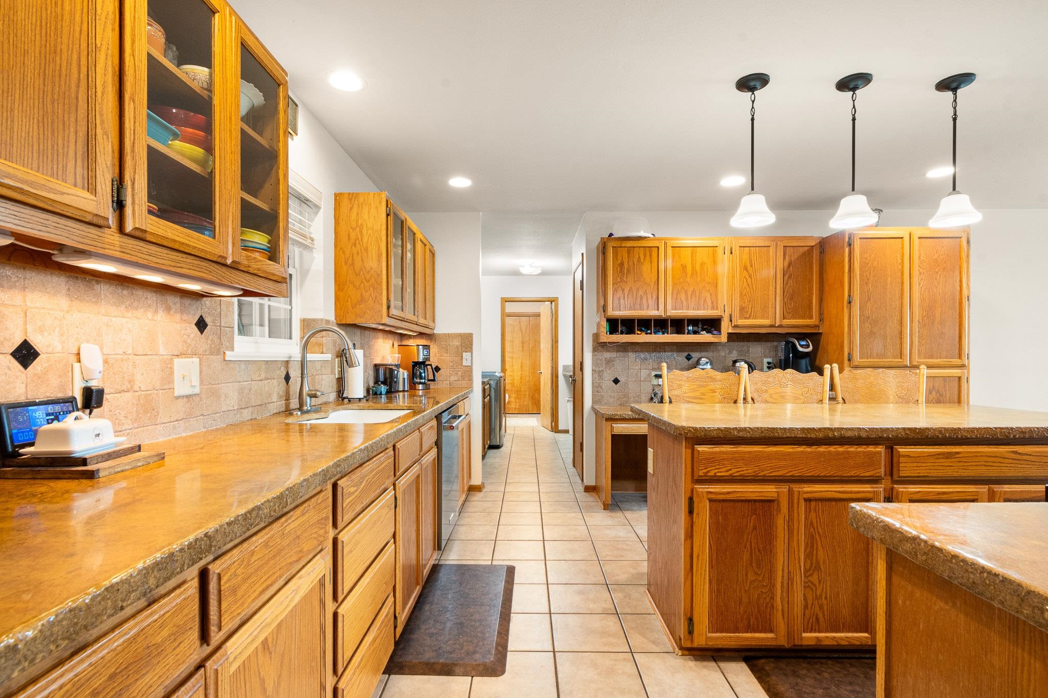 1185-17 17 1/2 Road Fruita, CO 81521 - Photo 10 of 35 a kitchen with stainless steel appliances granite countertop a sink and cabinets