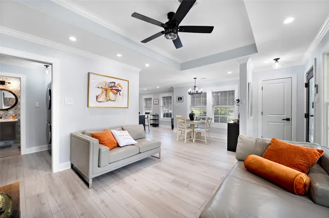 a living room with furniture and a view of kitchen