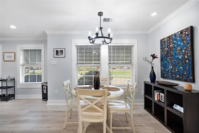 a view of a dining room with furniture and windows