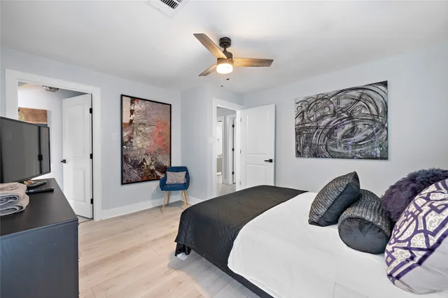 a bedroom with a bed and a chandelier