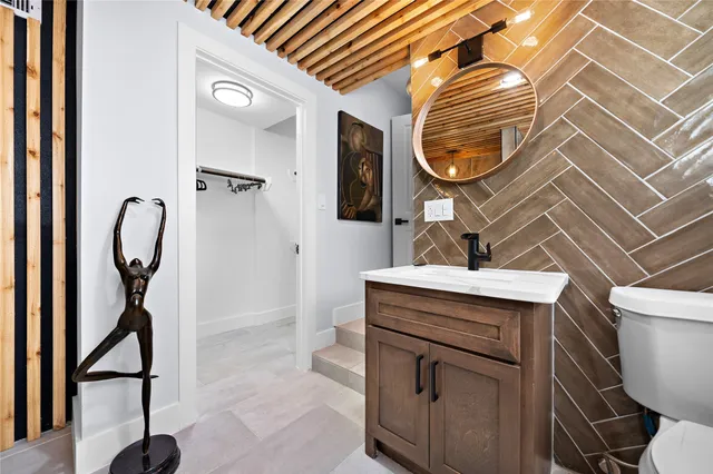 a bathroom with a sink a mirror and a shower