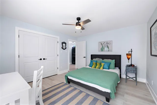 a bedroom with a bed and a chandelier