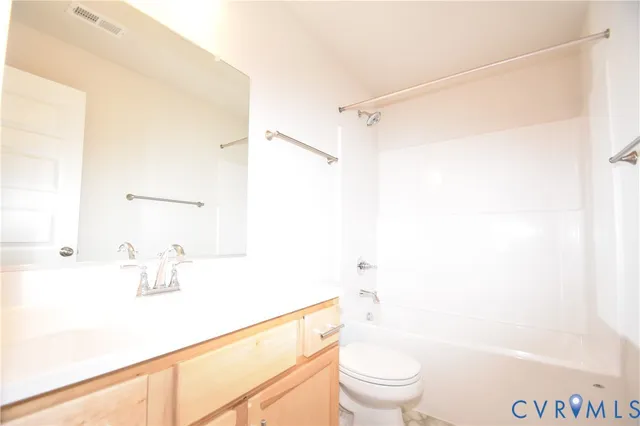 a bathroom with a shower a sink and a toilet