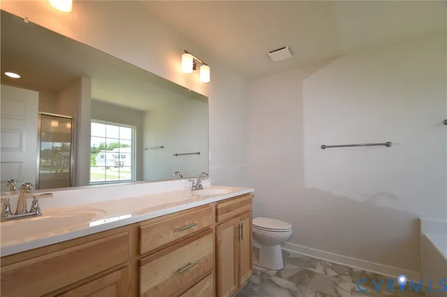 a bathroom with a sink toilet and mirror