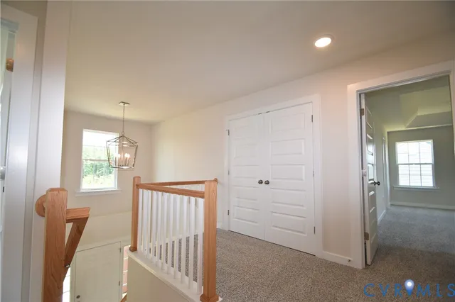 a view of a hallway with windows and stairs