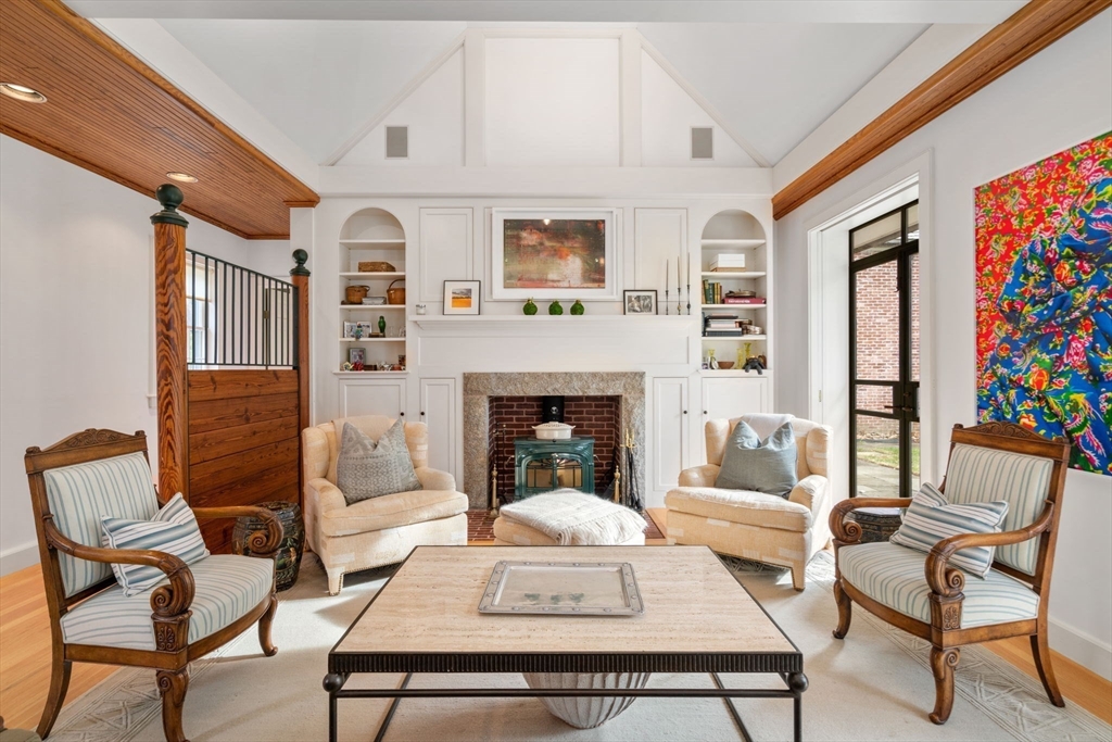 a living room with furniture a fireplace and a table