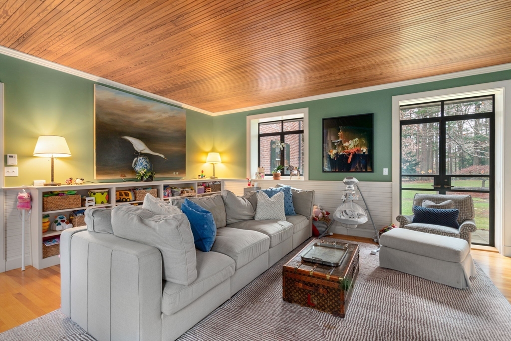 164 Forest Street, Unit 164 Sherborn, MA 01770 - Photo 13 of 32 a living room with furniture and a flat screen tv
