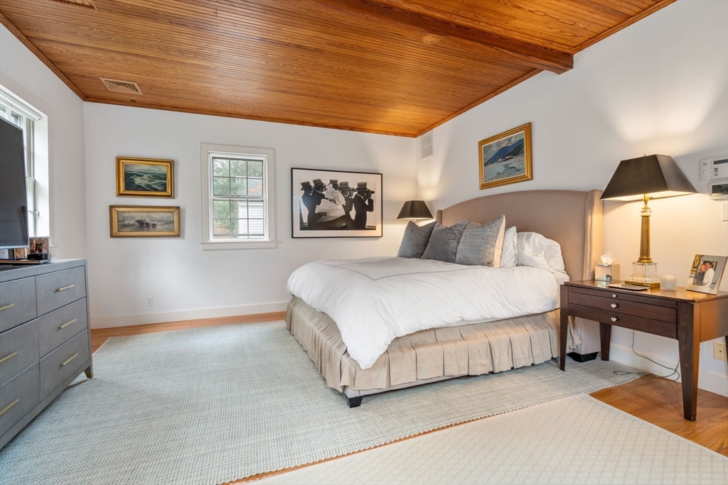 164 Forest Street, Unit 164 Sherborn, MA 01770 - Photo 15 of 32 a spacious bedroom with a bed and a night stand