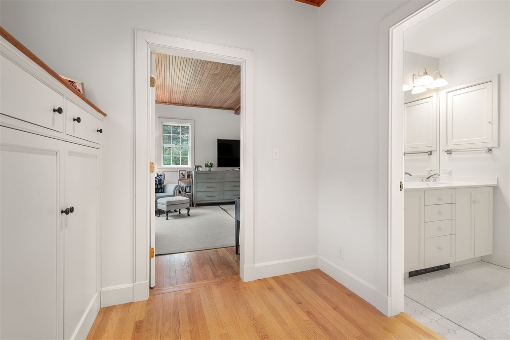 164 Forest Street, Unit 164 Sherborn, MA 01770 - Photo 17 of 32 a en suite bathroom with a sink and a mirror
