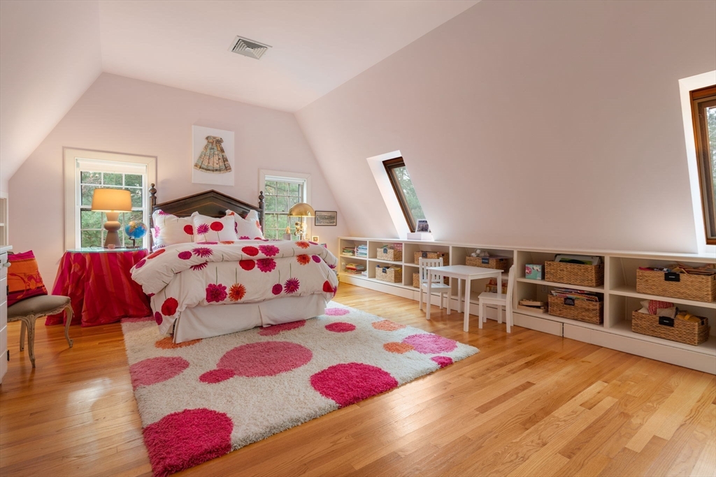 164 Forest Street, Unit 164 Sherborn, MA 01770 - Photo 18 of 32 a bedroom with a bed and wooden floor