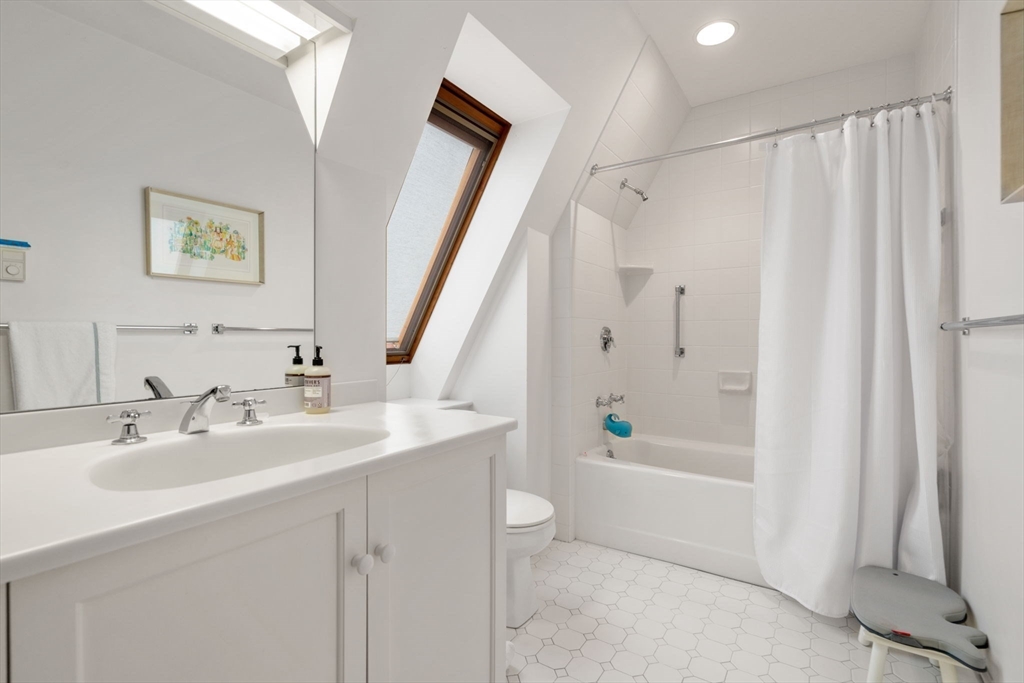 164 Forest Street, Unit 164 Sherborn, MA 01770 - Photo 19 of 32 a bathroom with a sink a toilet and shower