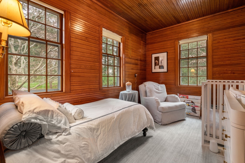 164 Forest Street, Unit 164 Sherborn, MA 01770 - Photo 22 of 32 a bedroom with bed couch and window